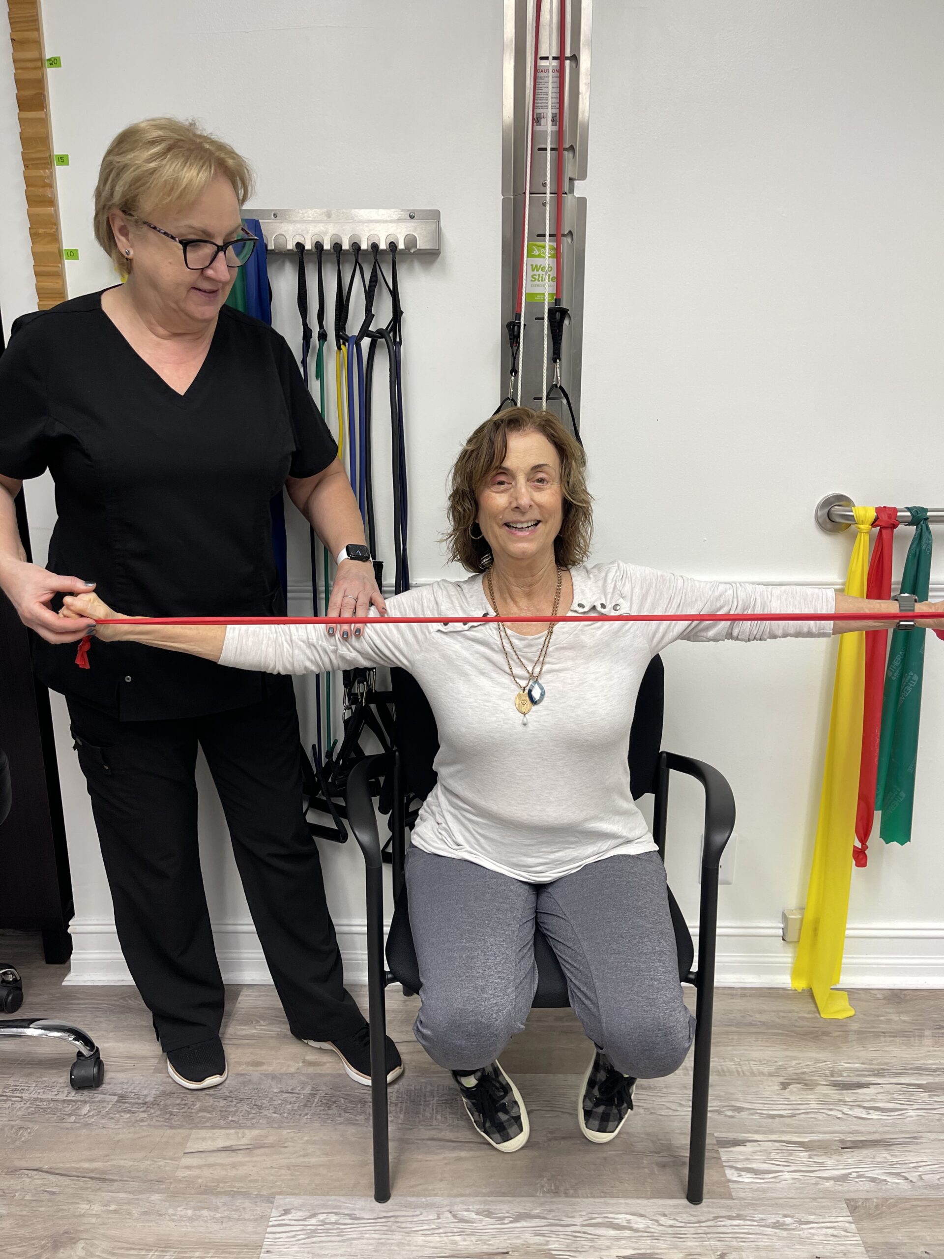 Elderly patient undergoing one-on-one physical therapy session to enhance posture and mobility with therapist guidance in Deerfield Beach.