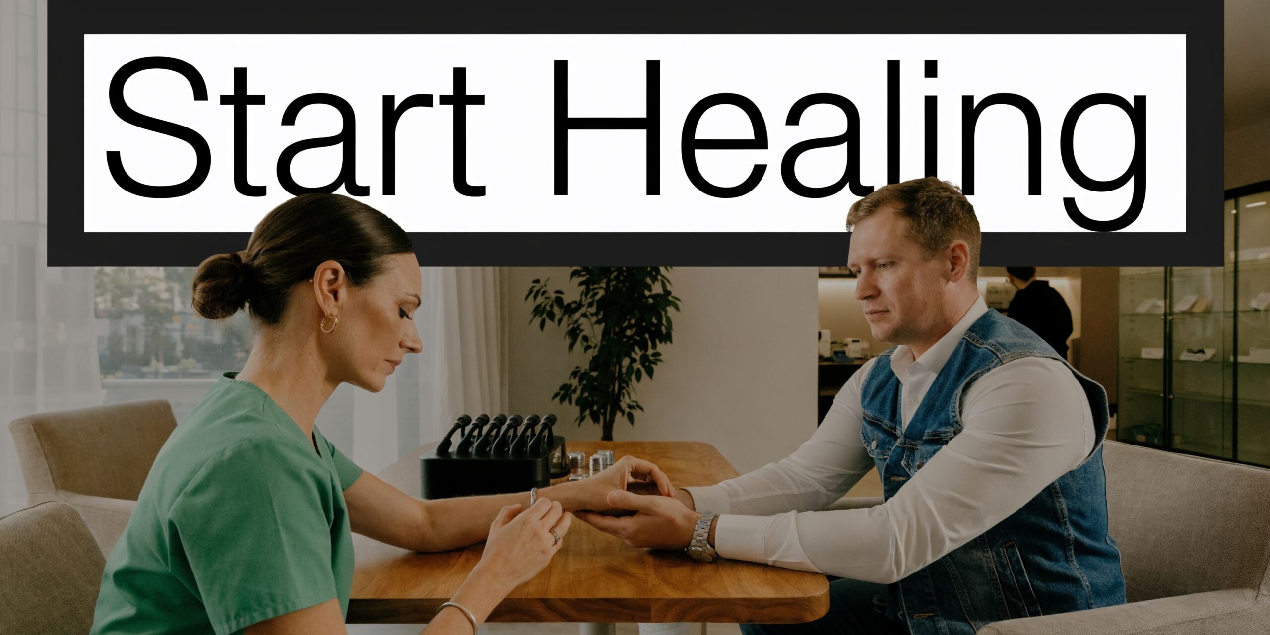 A physical therapist conducting a hands-on assessment with a male patient at a modern clinical office.