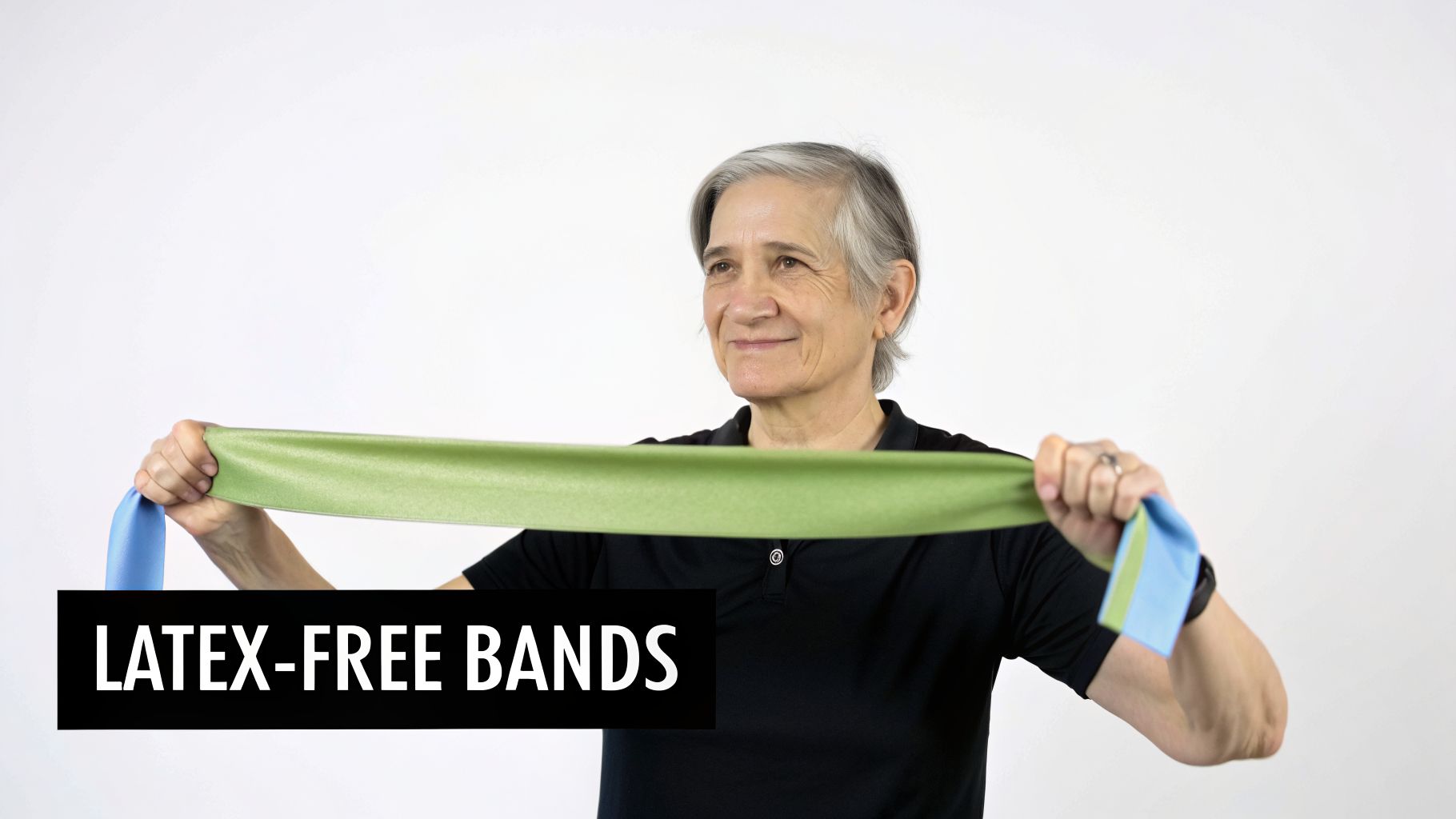 An older woman smiles while holding and stretching a green and blue latex-free resistance band.
