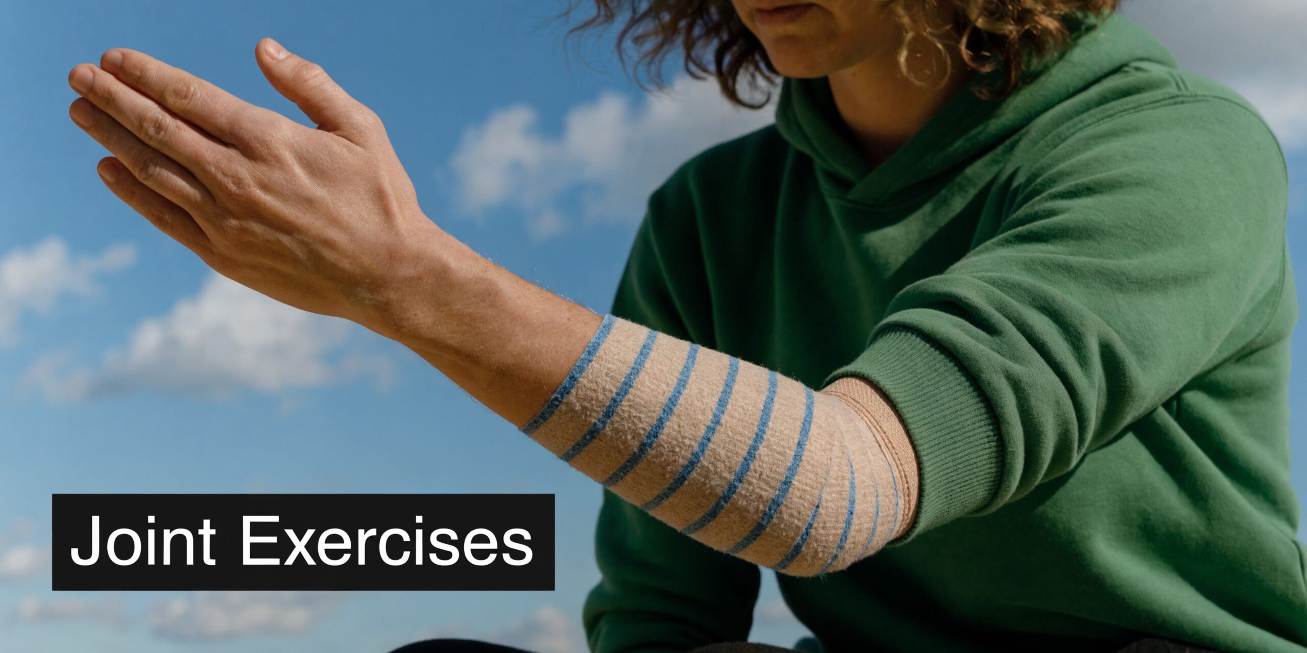 A person wearing an elastic compression wrap on their forearm while performing gentle joint physical therapy exercises.