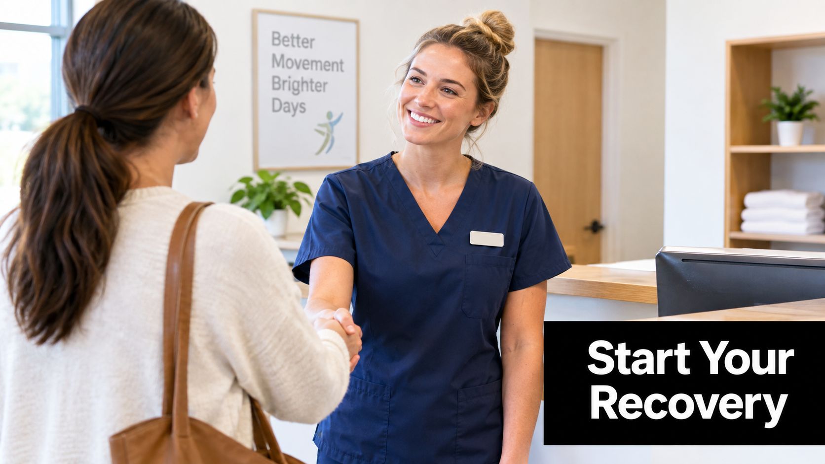 A friendly physical therapist in blue scrubs shakes hands with a patient at a reception desk.