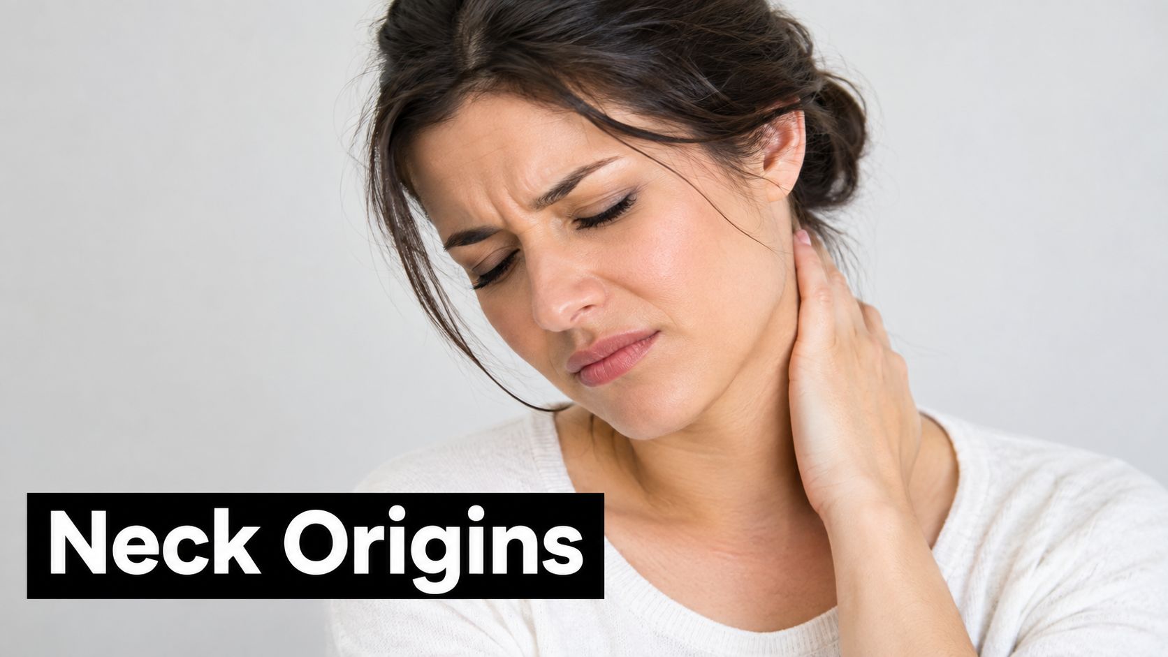 A woman experiencing pain in her neck and holding it with her hand, suggesting neck discomfort.
