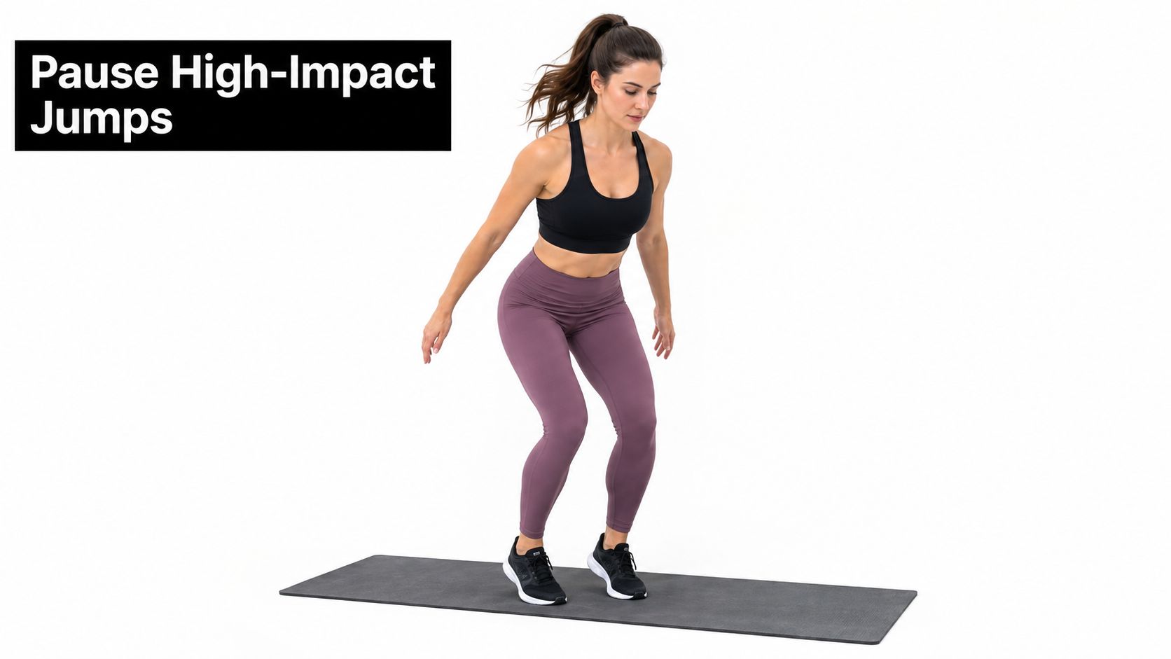 A woman performing a high-impact jump exercise on a yoga mat to improve lower body strength.
